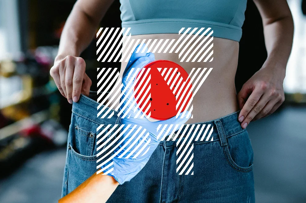 Close-up of a woman wearing a sports bra and showing loose-fitting jeans, symbolizing successful weight loss and improved gut health through balanced gut bacteria and a healthy metabolism.